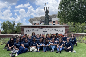  The Gandhi King student and faculty participants in front of a University of Alabama sign